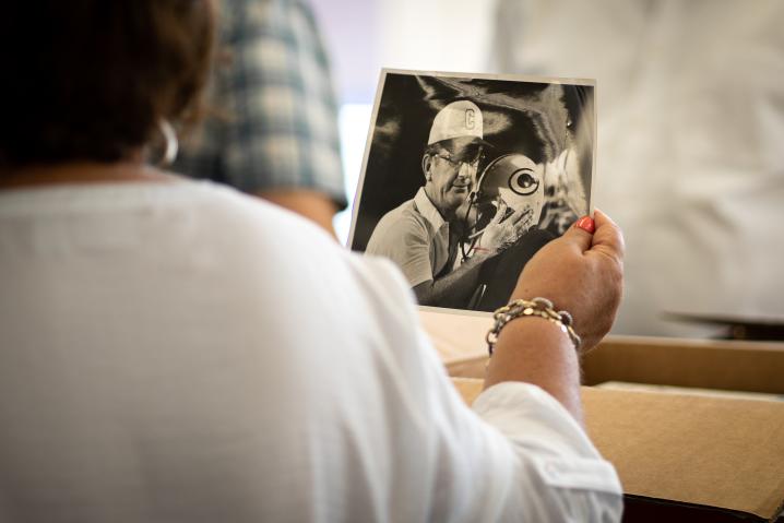 Nasia Butcher holds a photo of Coach Frank Vincent