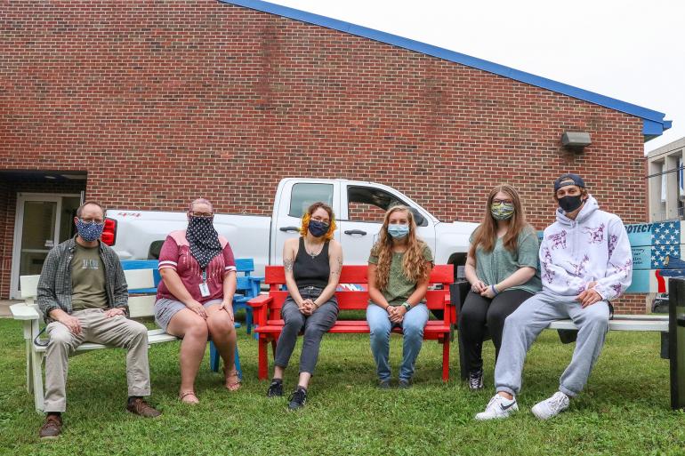 (l-r) Chris Cosner, Carla Bowman, Zoe Yates, Clair Amos, Brianna Deel, and Hayden Coon with a few of the benches that were refreshed by the GSC Art Society (GSC Photo/Kristen Cosner)