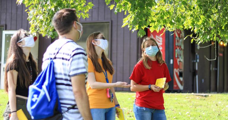 Glenville State College biology students Brittney Jenkins, Hannah Guthrie, and Emily Turner discuss tree foliage during a trip to Cedar Creek State Park with Science and Mathematics Department Lab Manager Chris Carver (second from left).