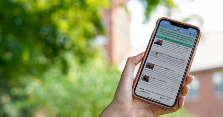 The Clio smartphone app displays a few of the historic entries around the Glenville area, including the Glenville State College Clock Tower which is pictured in the background. (GSC Photo/Kristen Cosner)