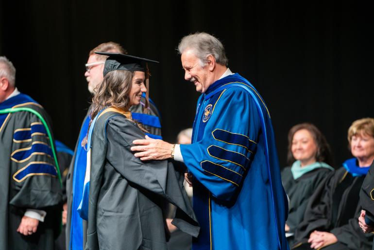 Fall 2024 MBA Graduate Hannah DeMarino and GSU Mark A. Manchin at GSU Fall Hooding Ceremony