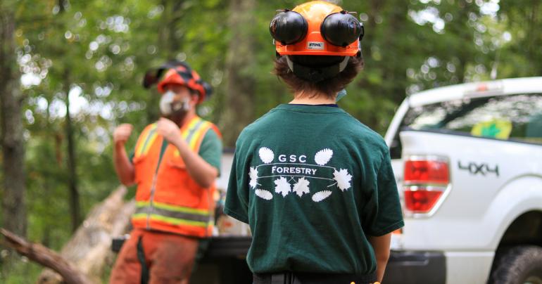 A Glenville State College forestry student listens as instructions are shared by a WV Division of Forestry employee. (GSC Photo/Kristen Cosner)