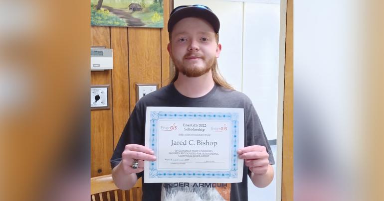 Jared Bishop with the certificate for his recent EnerGIS scholarship.