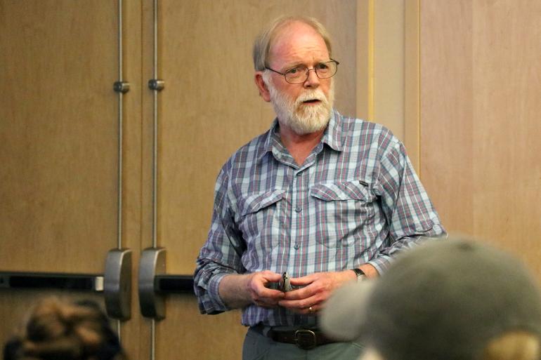 Dr. Michael E. Nelson speaking at his presentation