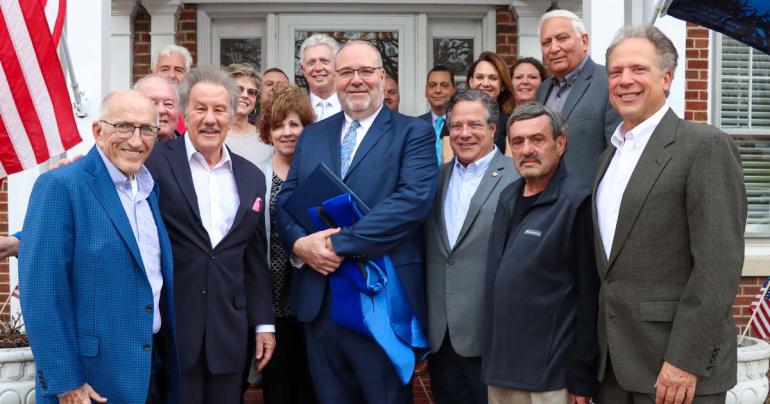 Surrounded by family, friends, and colleagues, West Virginia Board of Education President Paul Hardesty (center) was recently presented with an honorary degree from Glenville State University. (GSU Photo/Dustin Crutchfield)