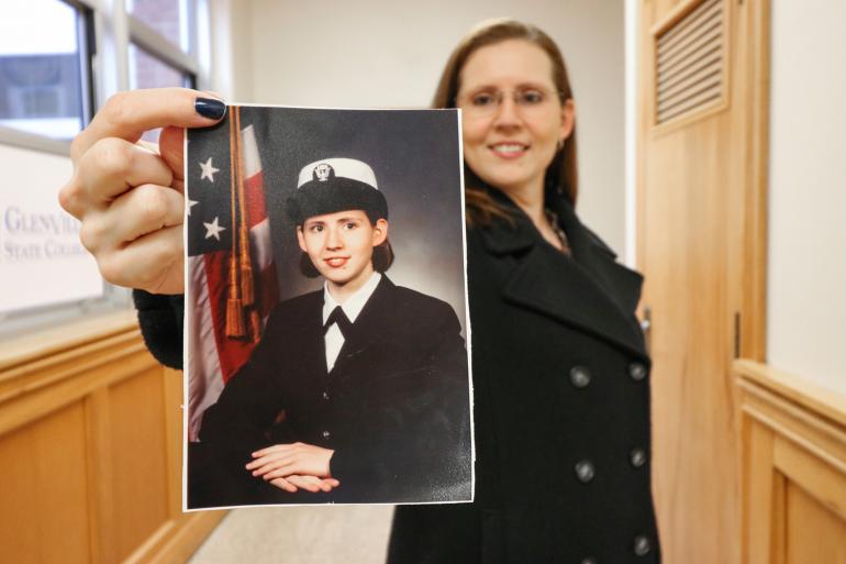 Glenville State College student veteran Sabrina Gonzalez holds a service-era photo of herself (GSC Photo/Kristen Cosner)