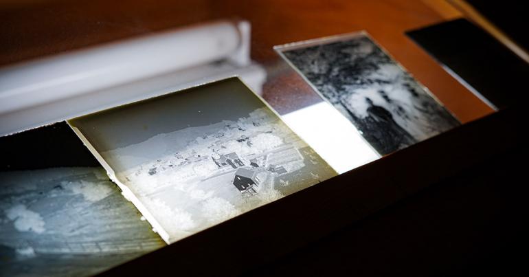 Several glass negatives, which were donated to the Glenville State College Archives, are displayed on a light box. (GSC Photo/Kristen Cosner)