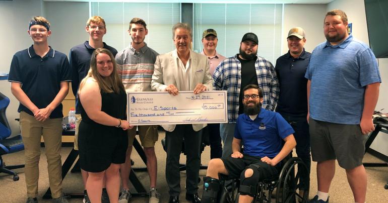 Glenville State College President Dr. Mark Manchin (center, holding check) is joined by Pioneer eSports students Aden Knopp, Adam Davis, Abigail Taylor, Noah Schultz, Justin Sodergren, Sterling Gandee, Chris Anglin, Austin Cochran and eSports Coach Logan Harrison.