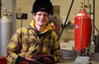 Glenville State College student Jesse Kargol with some of his welding designs (GSC Photo/Kristen Cosner)